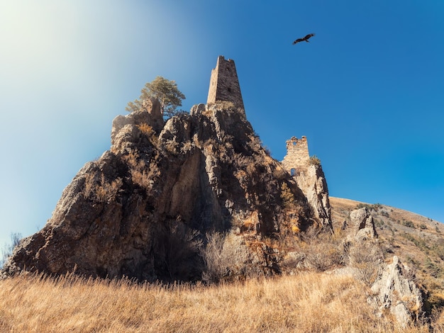 Sunny afternoon in the Caucasus mountains Medieval tower complex Vovnushki one of the authentic medieval castletype tower villages located on the extremity of the mountain range in Ingushetia