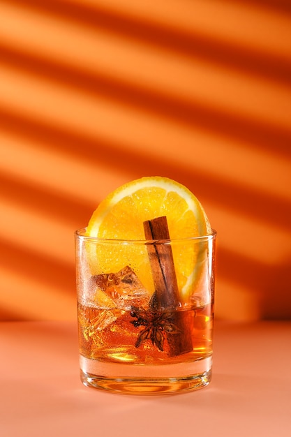 Sunny cocktail with brandy and orange liquor, cinnamon and star anise