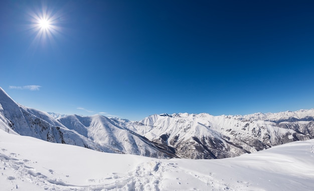 Sunny day on snowcapped mountain range