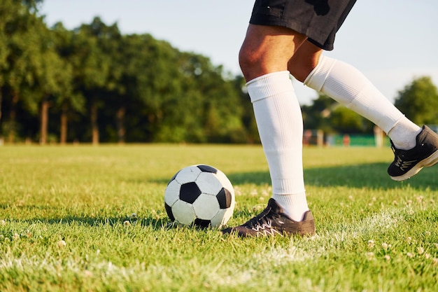 Sunny daytime Young soccer player have training on the sportive field