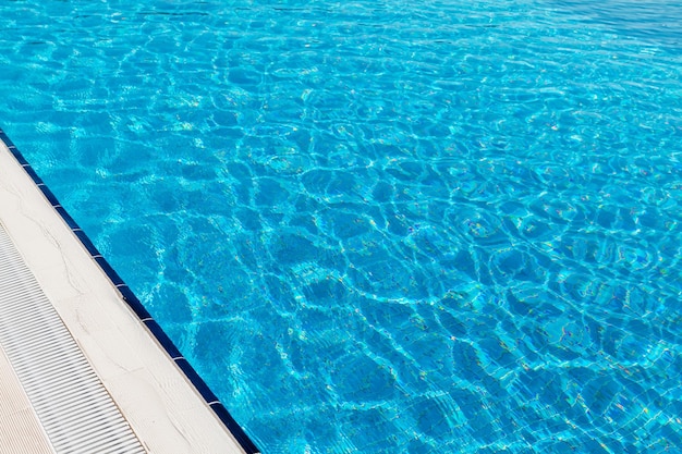 Sunny swimming pool in tropical resort