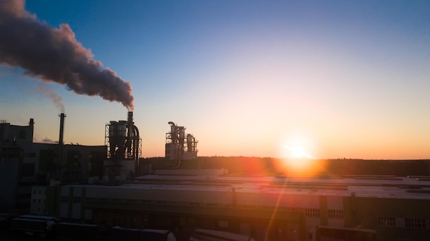 Sunrise over the factory The smoke comes from the pipes at dawn