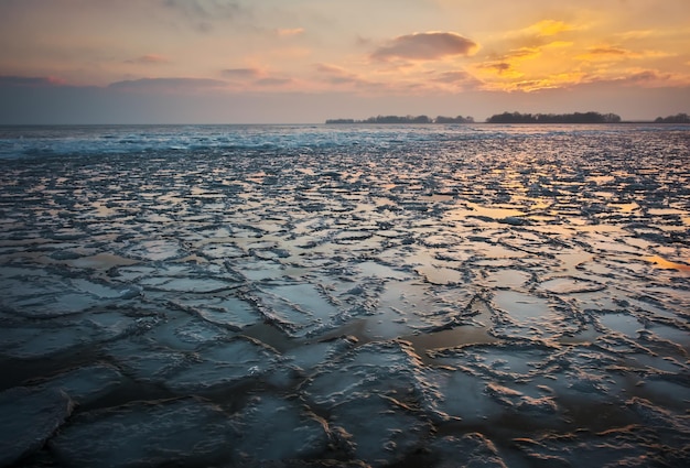 Sunrise and frozen sea Beautiful winter landscape with lake in morning time