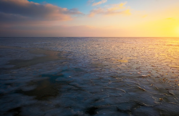 Sunrise and frozen sea Beautiful winter landscape with lake in morning time