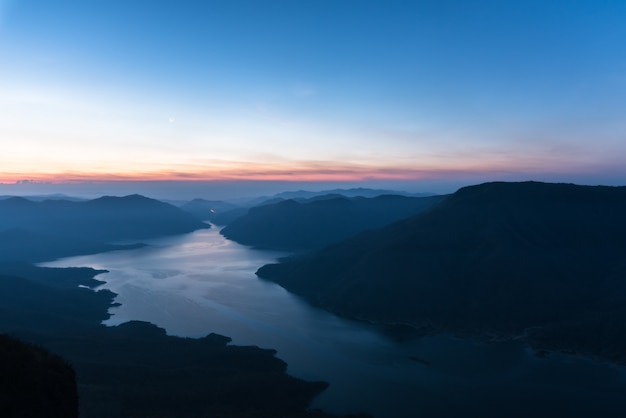 Sunrise above the lake and mountain