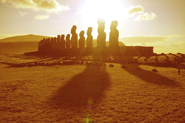 sunrise over moai statues at ahu tongariki on easter island chile south america in golden color