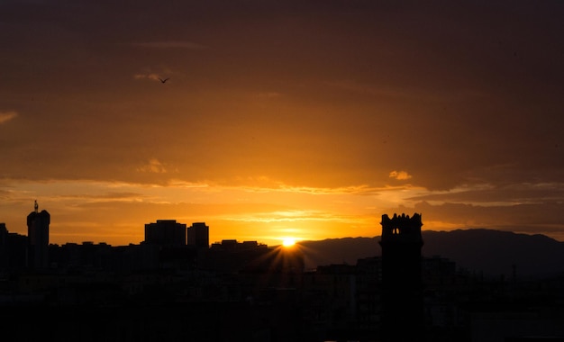 Sunrise over Naples, Italy. Rising sun with buildings silhouettes. Morning and sunrise concept.