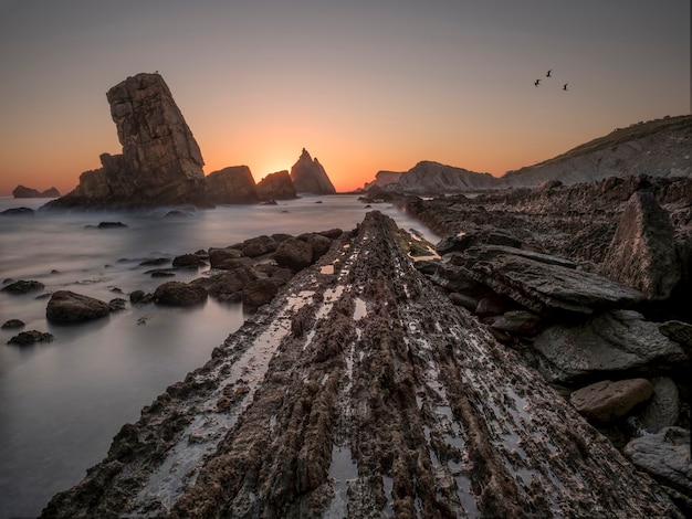 Sunrise on the rocks by the sea