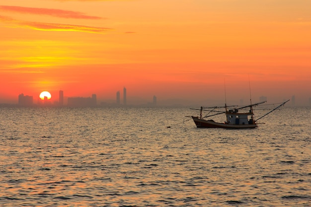 Sunrise over the sea with fishing boat