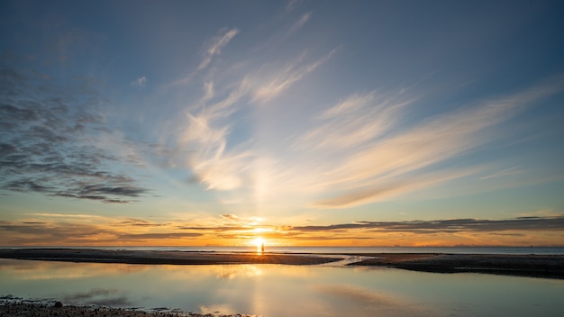 Sunrise shot over the sea and beautiful cloud. sun disappeared behind a big cloud over ocean.