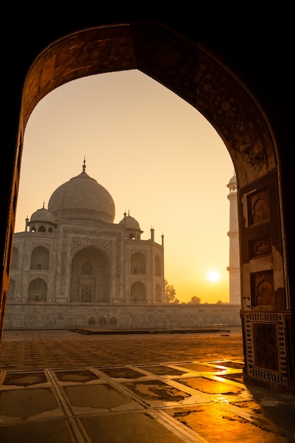 Sunrise of Taj Mahal through an archway in Agra India shot in high iso.