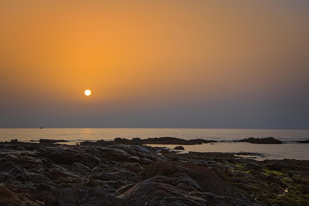 Sunrise with calima on the Costa del Sol Calaburras lighthouse beach Mijas Malaga Spain