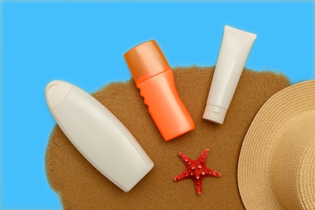 Photo sunscreen natural cosmetics for skin care on the sand in summer sun hat