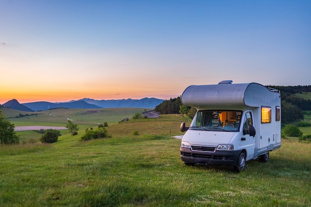 Sunset clear sky over camper van in Montelago highlands, Marche, Italy