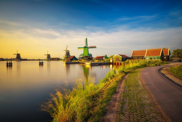 Sunset above farm houses and windmills of Zaanse Schans in the Netherlands