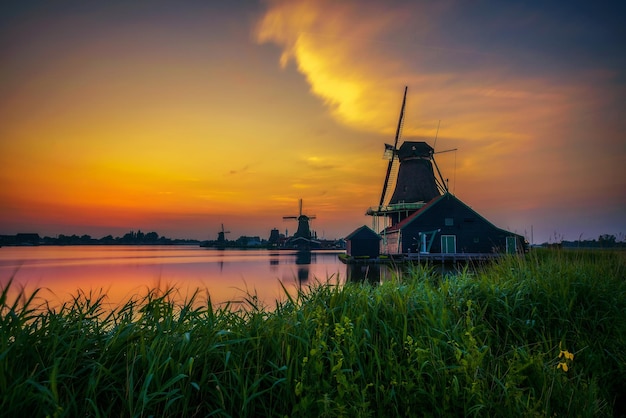 Sunset above farm houses and windmills of Zaanse Schans in the Netherlands