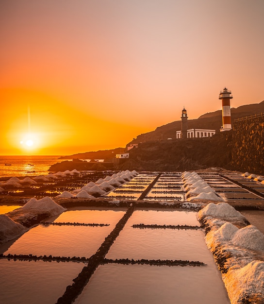 Sunset at the Fuencaliente Lighthouse next to the salt flats, on the route of the volcanoes south of the island of La Palma, Canary Islands, Spain