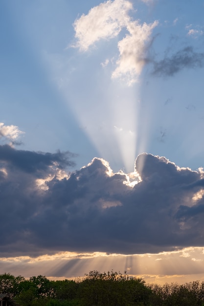 Sunset hidden behind moving clouds, thunderstorm.