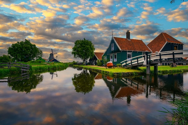 Sunset above historic farm houses in the holland village of zaanse schans