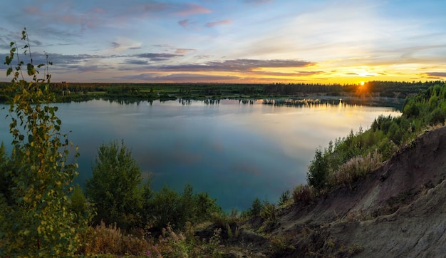 Sunset over the horizon and at the water quarry Leningrad region Vsevolozhsk