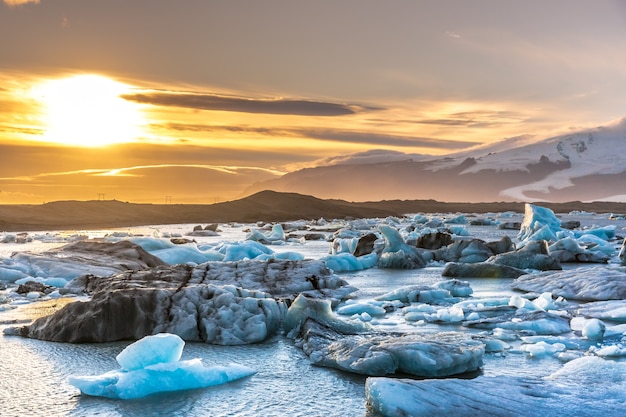 Sunset at the iceberg lagoon in Iceland, snow cape mountains 