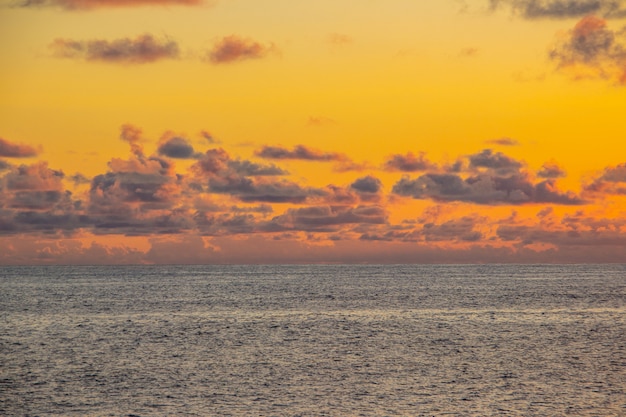 Sunset in ipanema with orange sky and clouds