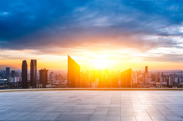 a sunset is seen from a rooftop with a blue sky and clouds