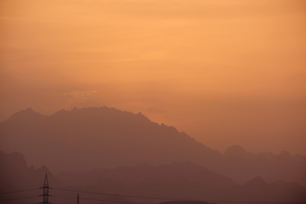 Sunset landscape with dark mountain peaks in egyptian desert