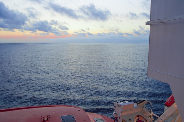 Sunset on the Mediterranean sea, a beautiful view from the cruise ship, visible lifeboats