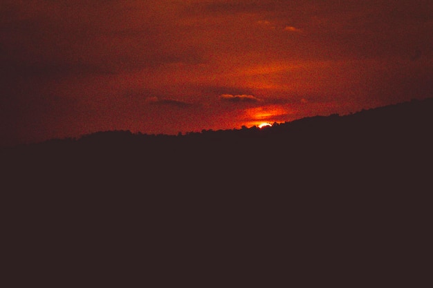 At sunset mountain landscape of silhouette   Sun Setting Behind Mountains  Sunset Over Mountain