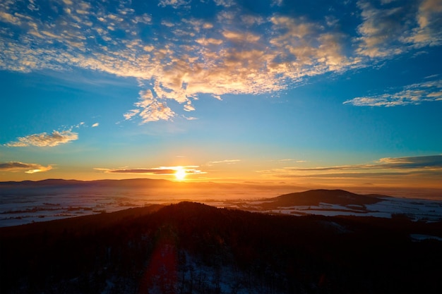 Sunset over mountains covered with forest