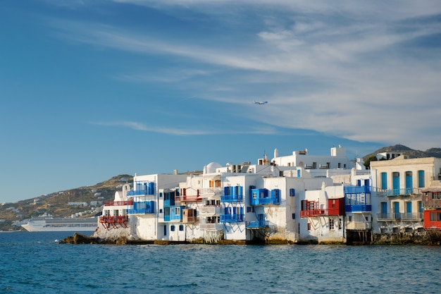 Sunset in Mykonos, Greece, with cruise ship and yachts in the harbor