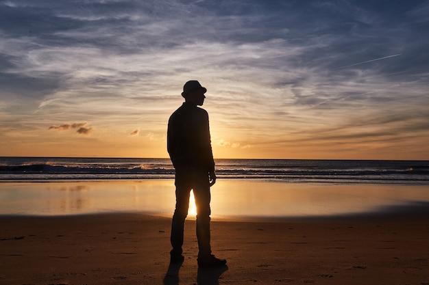 Sunset ocean beach of Spain Andalusia. Atlantic Ocean waves background bright magic summer sunset sky