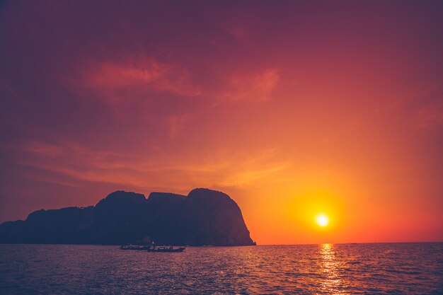 The sunset over the ocean and cliffs. Thailand.