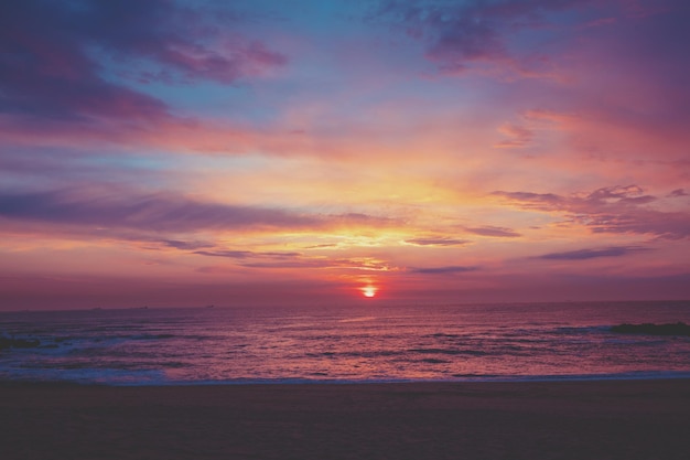 Sunset over the ocean Sandy beach at sunset Beautiful seashore in the evening Porto Portugal Europe