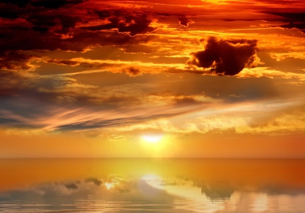 sunset orange yellow lilac cloudy night sky at  sea on beach sun beam  reflection