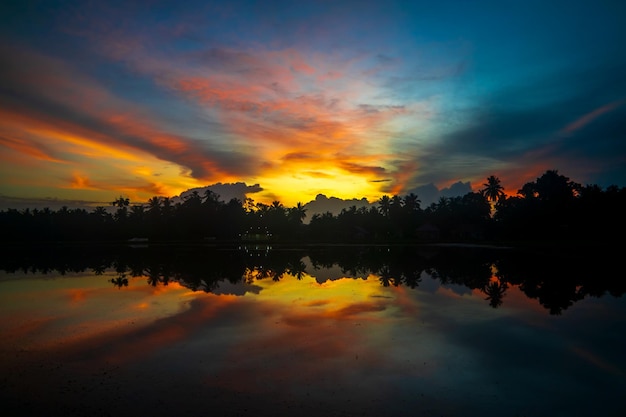 Sunset reflection on water. Dramatic sky background