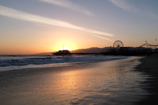 Sunset at Santa Monica Beach, California. The golden color of the sand. High quality photo