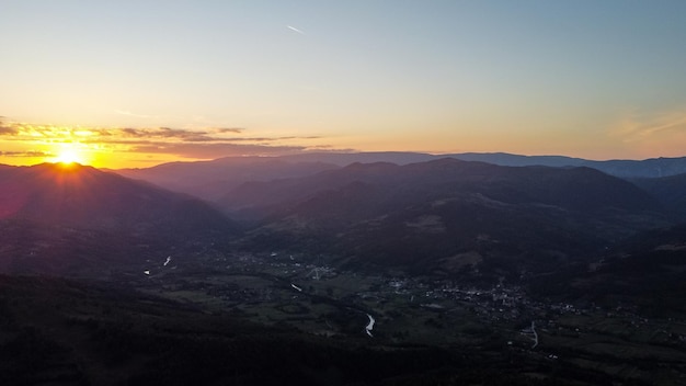 Sunset scene landscape with mountains peaks.