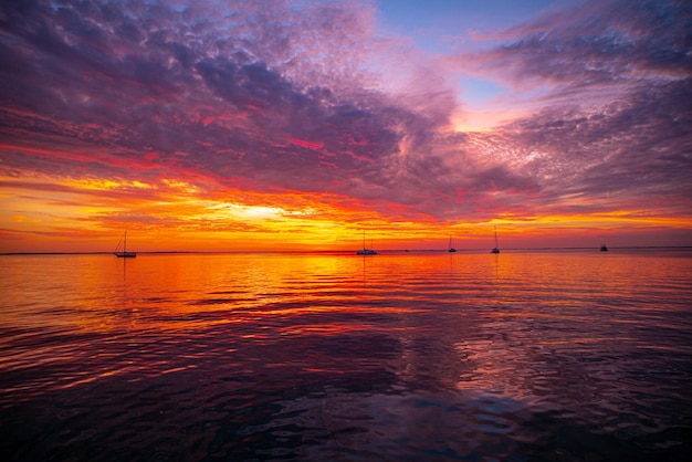 Sunset sea beach Bright sunset with large yellow sun under the sea surface