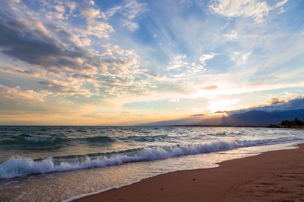 Sunset on the sea, beautiful mountains and clouds