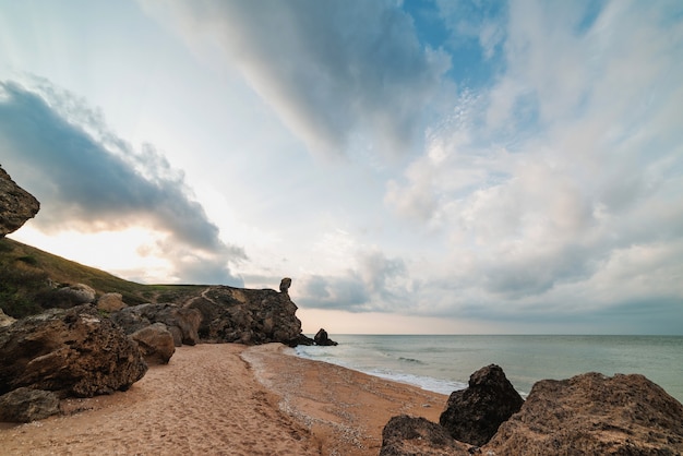 Sunset at sea. Scenic view of the sea, rocky coastline and sandy beach, outdoor travel background. General's beaches. Crimea.