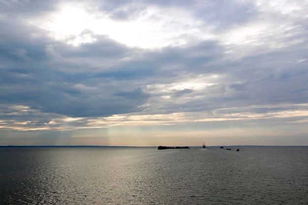 Sunset over the sea small islands and the ship sailing away into the distance