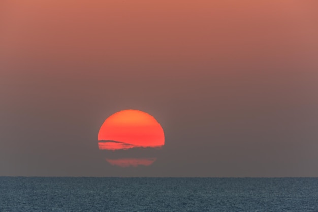 Sunset at sea with dramatic clouds.