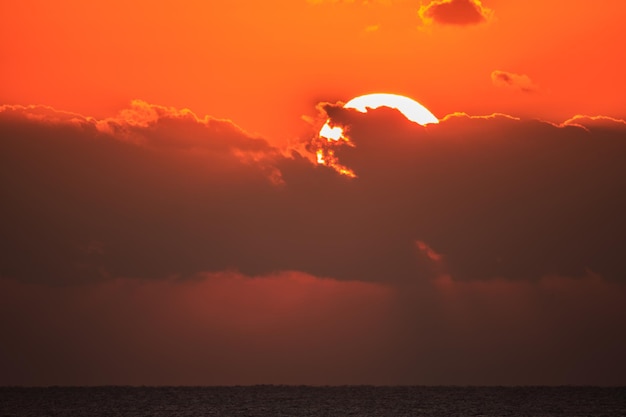 Sunset at sea with dramatic clouds.