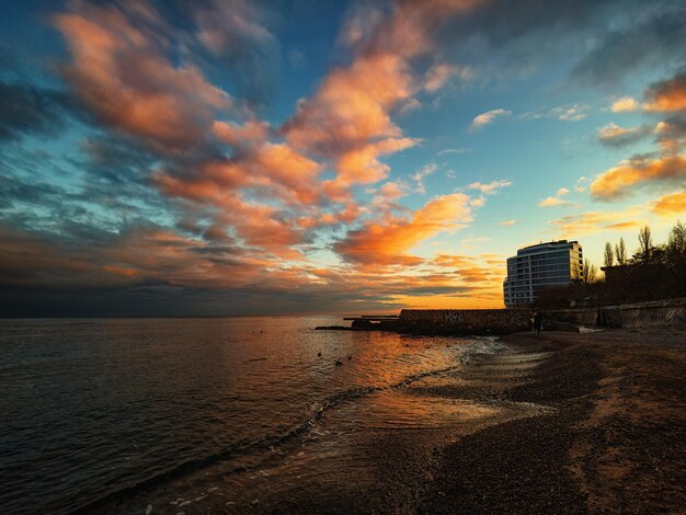 Sunset on the seashore with orangered clouds