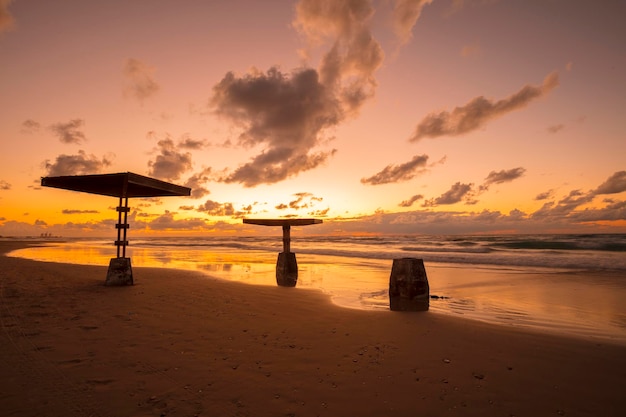 Sunset over seashore with sun umbrellas