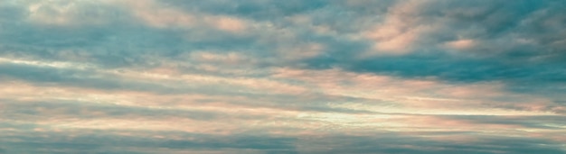 Sunset sky panorama pink blue clouds background cloudscape wide large banner size