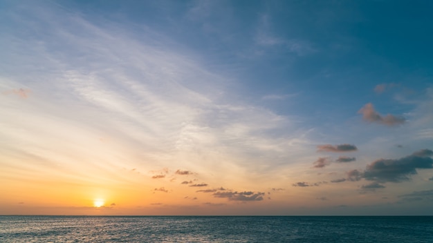 Sunset sky over sea in the evening with colorful orange sunlight