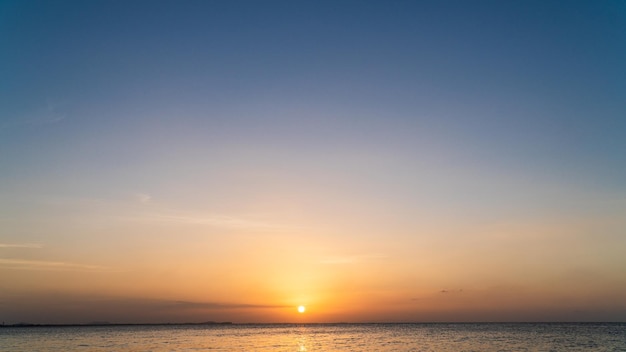 Sunset sky over sea in the evening with orange sunlight golden hour Dusk sky background